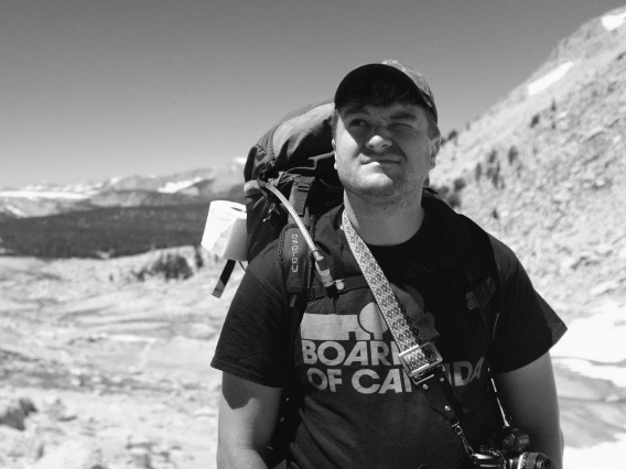 Black and white headshot of James Paules backpacking